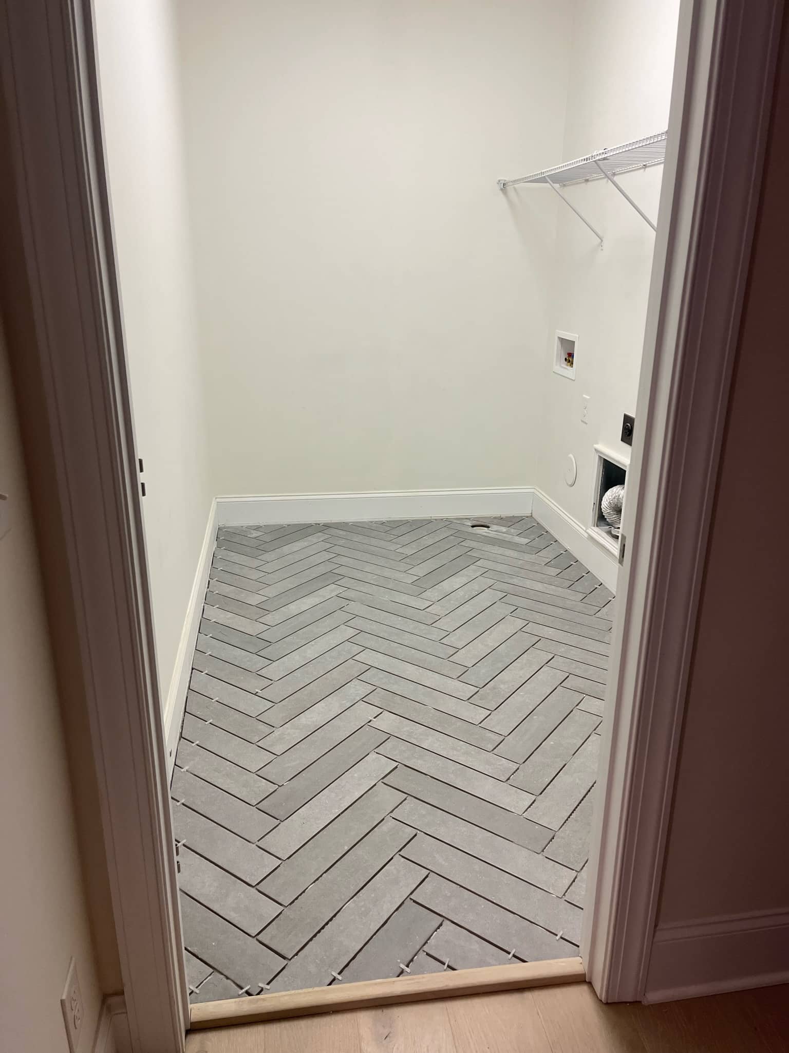 What Our Laundry Room Renovation Cost [Tile, Cabinets & More]